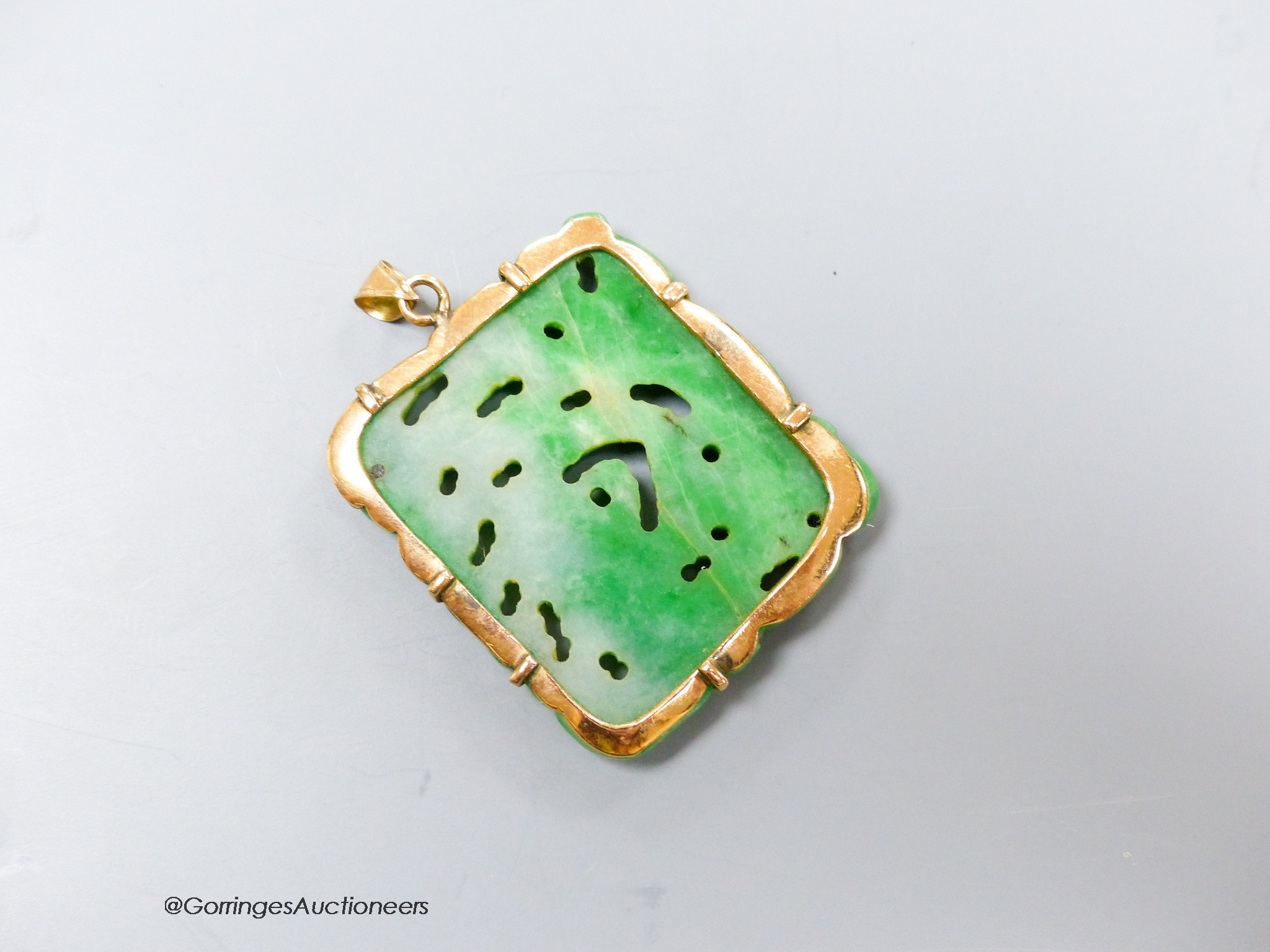 A yellow metal mounted jade pendant, carved with a fish, 37mm, gross weight 15.2 grams.